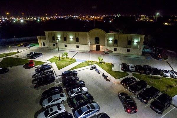 Aerial nighttime view of Bucks Cabaret Dallas and its illuminated parking lot